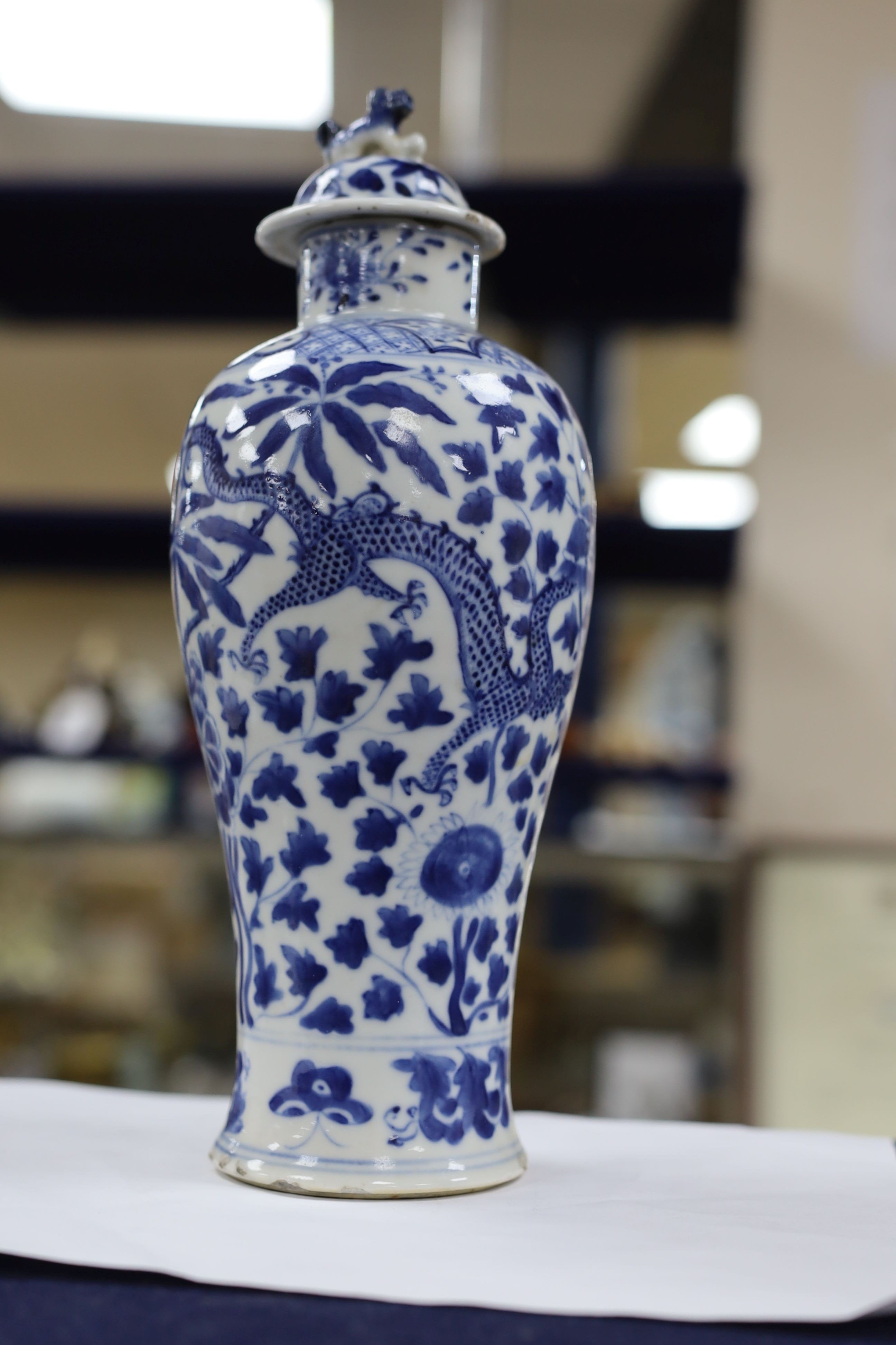 A pair of Chinese blue and white dragon vases and covers, circa 1900. 28cm